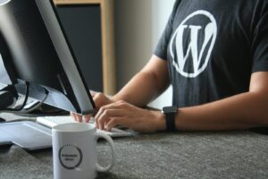 person in black and white t-shirt using computer team woocommerce